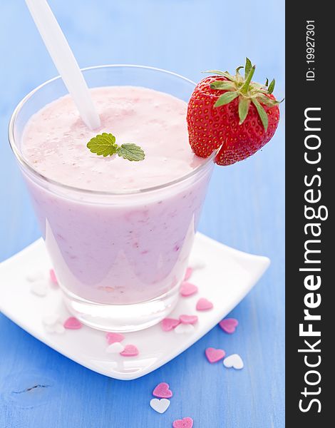 Fresh strawberry shake in a glass with spoon