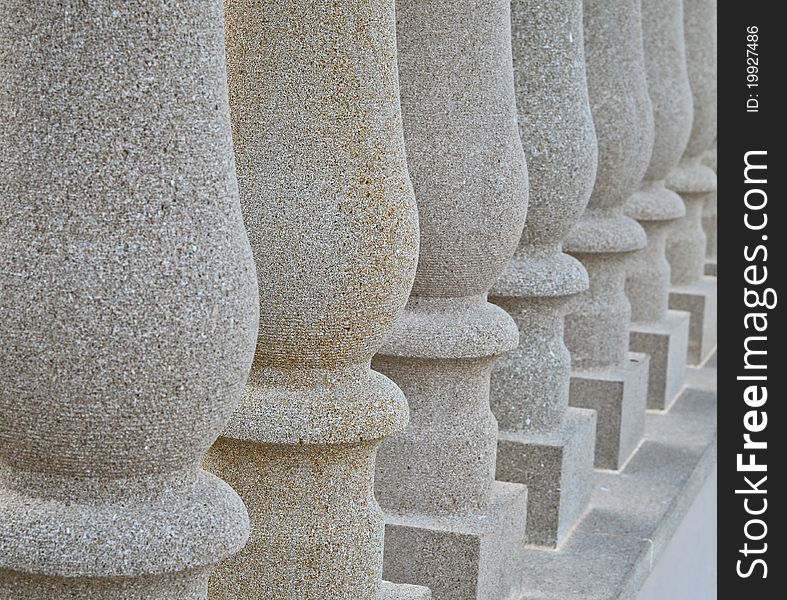 Solid stone pillars in a row with the second one in depicting the odd one out