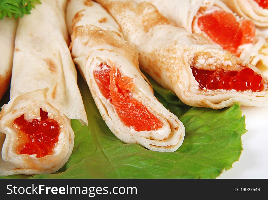 Pancakes with caviar and salmon. Close-up