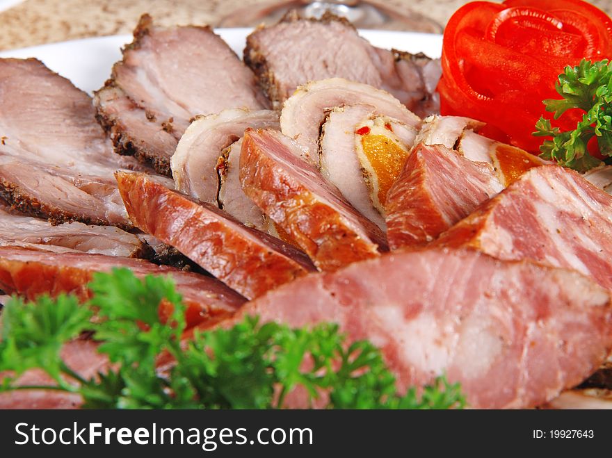 Meat and sausages with parsley and  vegetables. Closeup