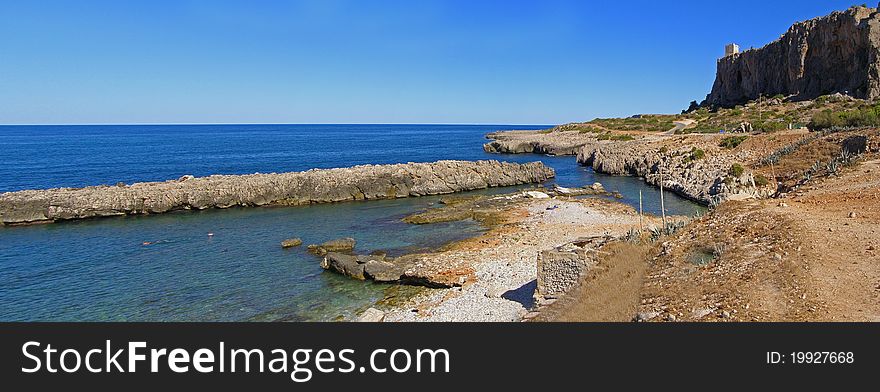 Beautiful natural landscape, view across the Macari Bay aof the Isuledda Beach and the watchtower Location: Macari Bay in Sicily, Italy, Europe Horizontal panoramic image, 2 horizontal images stitched together into a panoramic image. Beautiful natural landscape, view across the Macari Bay aof the Isuledda Beach and the watchtower Location: Macari Bay in Sicily, Italy, Europe Horizontal panoramic image, 2 horizontal images stitched together into a panoramic image