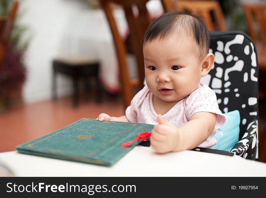 7 Month Old Asian Baby Girl, Holding The Menu