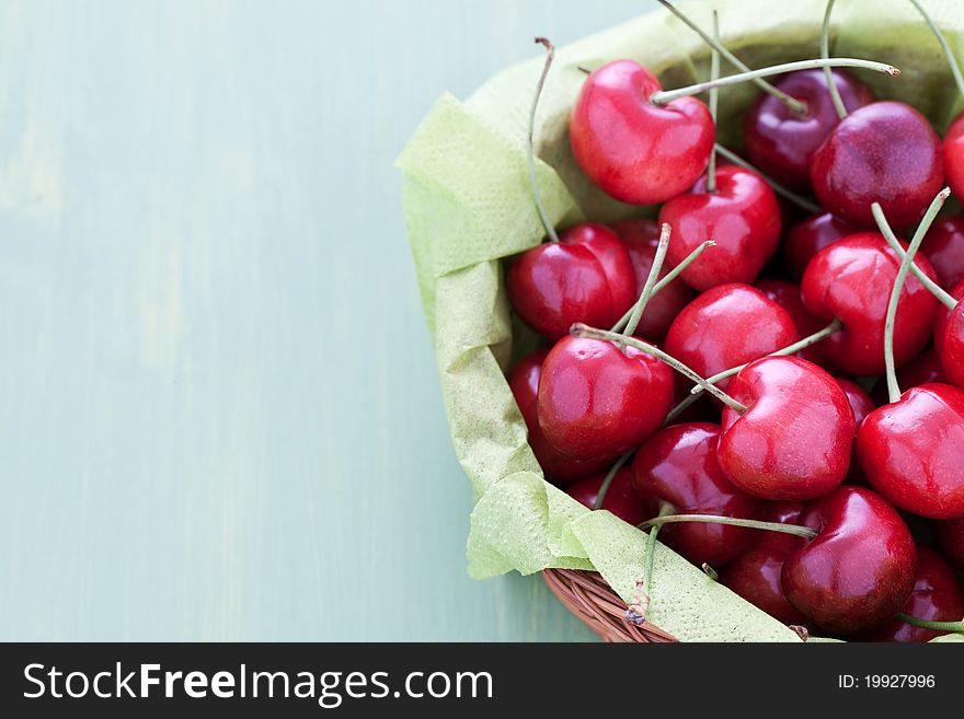 Fresh cherries in a basket with copy space