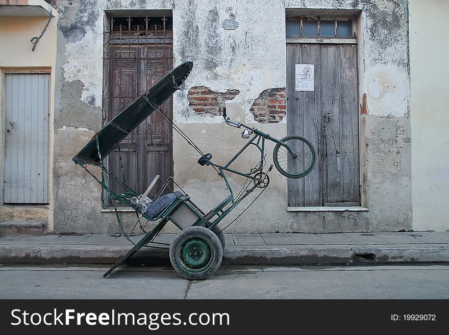 Three wheeler bike in the streets of a Cuban village. Three wheeler bike in the streets of a Cuban village