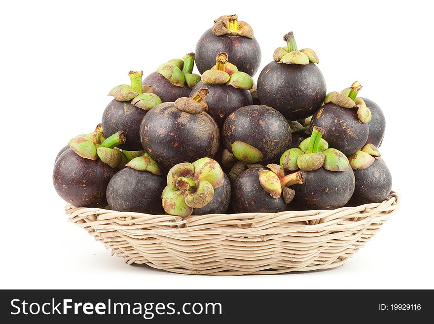 Isolated Mangosteens in a basket. Isolated Mangosteens in a basket