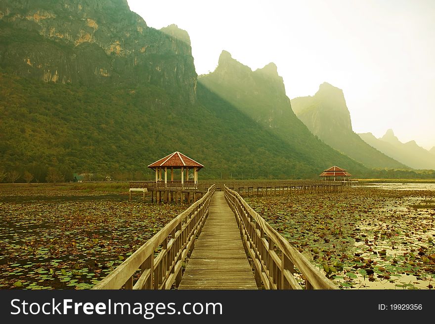Footbridge in lake into the mountain, thailand