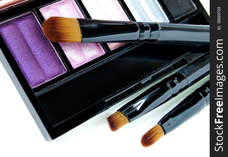 Make-up brush with colorful crushed eyeshadows. Make-up brush with colorful crushed eyeshadows