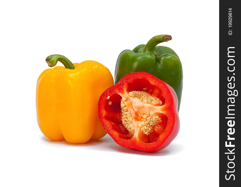 Three sweet peppers in yellow, red and green color