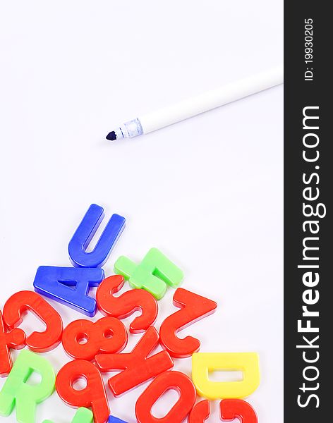 Colorful Letter Magnets And Pen On Whiteboard. Colorful Letter Magnets And Pen On Whiteboard