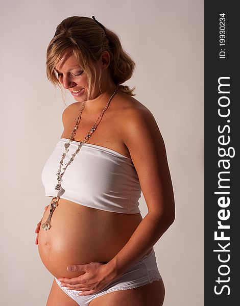 A pregnant woman posing with big belly. A pregnant woman posing with big belly