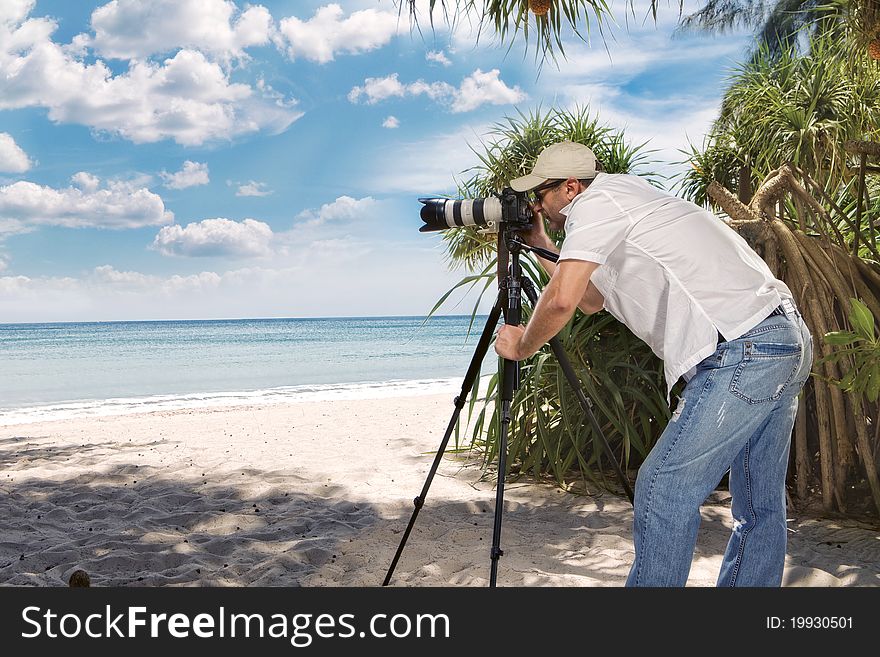 Portrait of photographer taking picture in tropical environment