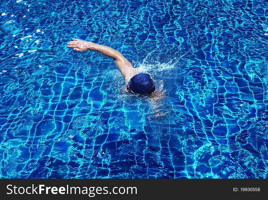 Portrait of young man swimming in pool