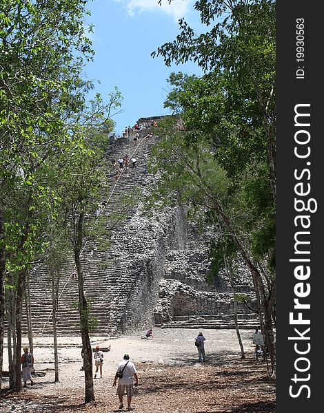 Tourists climb the top of the Coba Main pyramid, highest Maya structure standing 40 Meters above the Yucatan jungles. Tourists climb the top of the Coba Main pyramid, highest Maya structure standing 40 Meters above the Yucatan jungles.