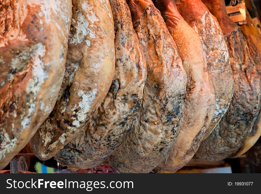 Row Of Ham Hanging In A Market Place