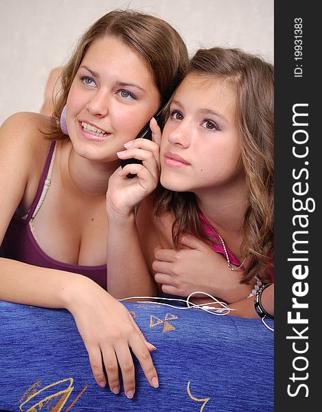 Two schoolgirls calling by the mobile phones