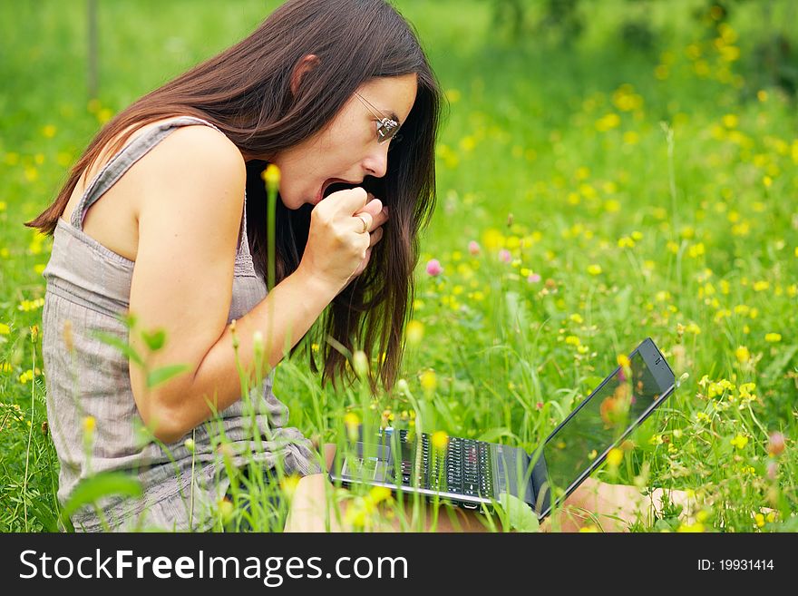 Shocked Young woman using her laptop outdoors. Shocked Young woman using her laptop outdoors.