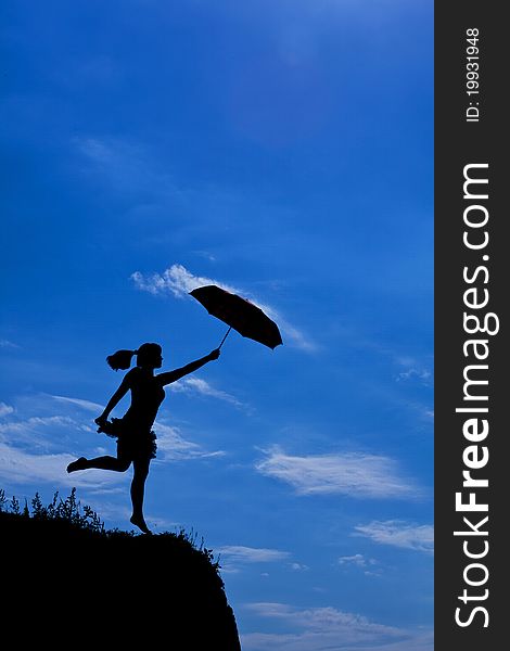 Silhouette of girl flight up with umbrella