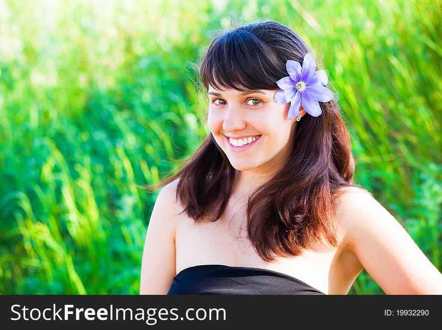 Beautiful Woman With Purple Clematis