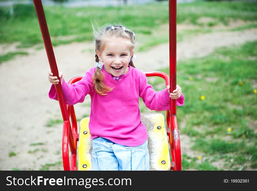 Cute little girl smiling in a park close-up