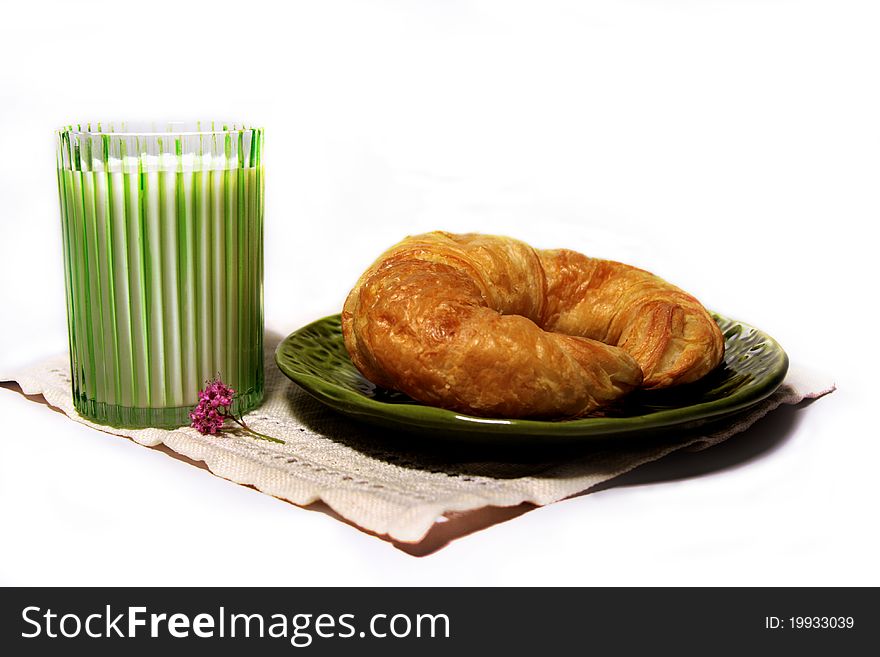 Croissant or crescent roll with glass of milk. Croissant or crescent roll with glass of milk.
