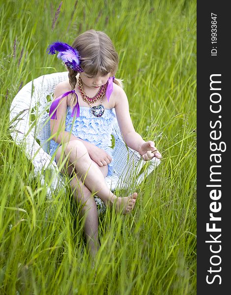 Little girl were a lace petti romper and a feather headband. Little girl were a lace petti romper and a feather headband