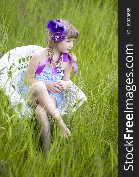 Little girl were a lace petti romper and a feather headband. Little girl were a lace petti romper and a feather headband