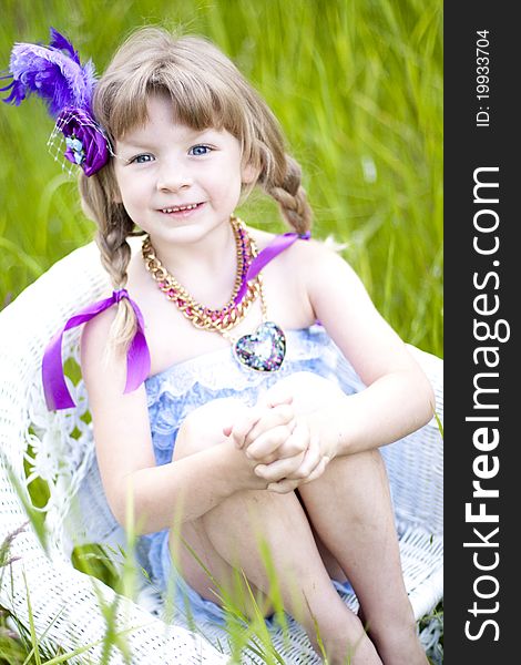 Little girl were a lace petti romper and a feather headband. Little girl were a lace petti romper and a feather headband