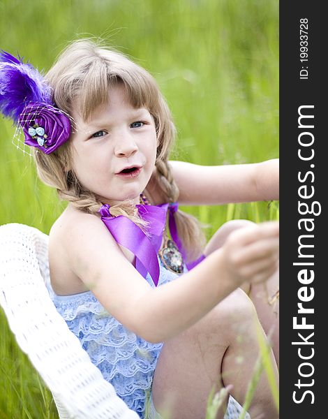 Little girl were a lace petti romper and a feather headband. Little girl were a lace petti romper and a feather headband