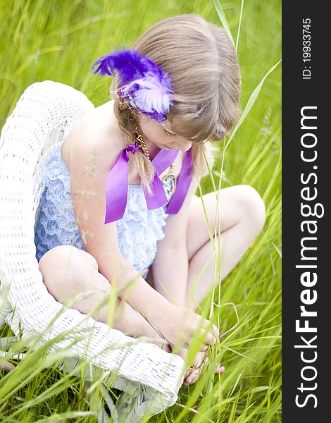 Little girl were a lace petti romper and a feather headband. Little girl were a lace petti romper and a feather headband