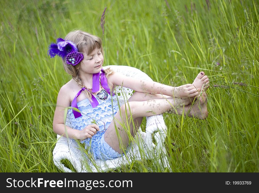 Little girl were a lace petti romper and a feather headband. Little girl were a lace petti romper and a feather headband