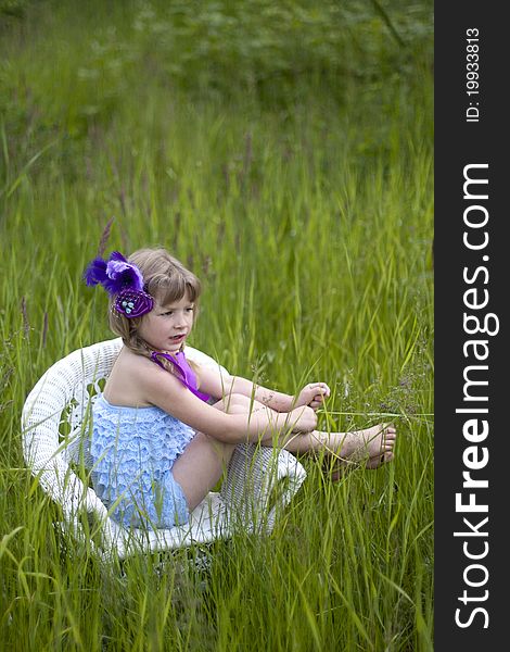 Little girl were a lace petti romper and a feather headband. Little girl were a lace petti romper and a feather headband