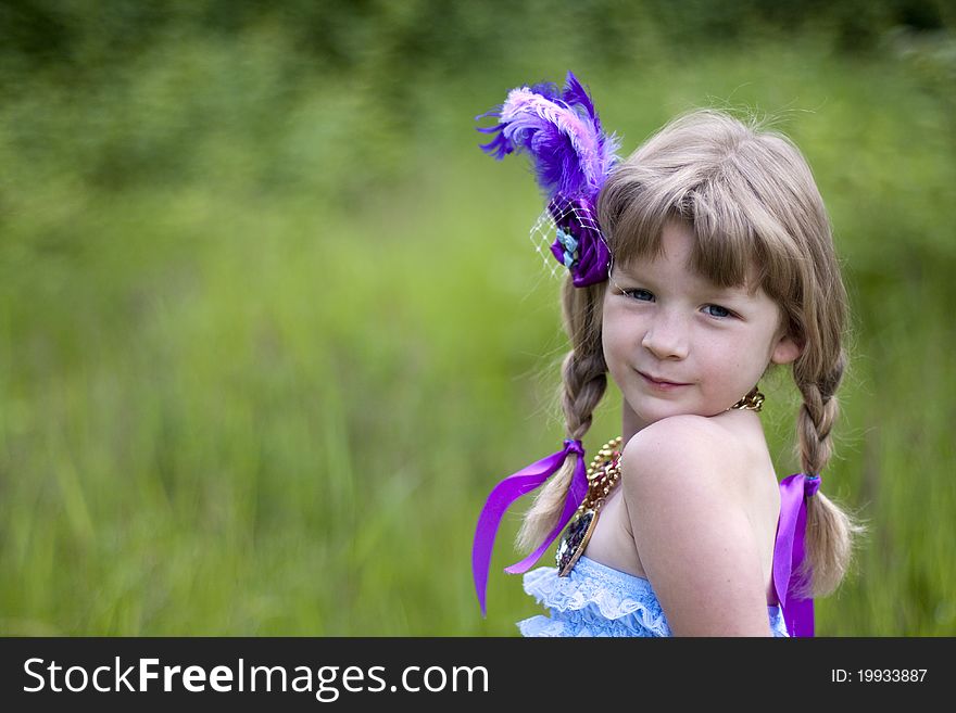 Little girl were a lace petti romper and a feather headband. Little girl were a lace petti romper and a feather headband