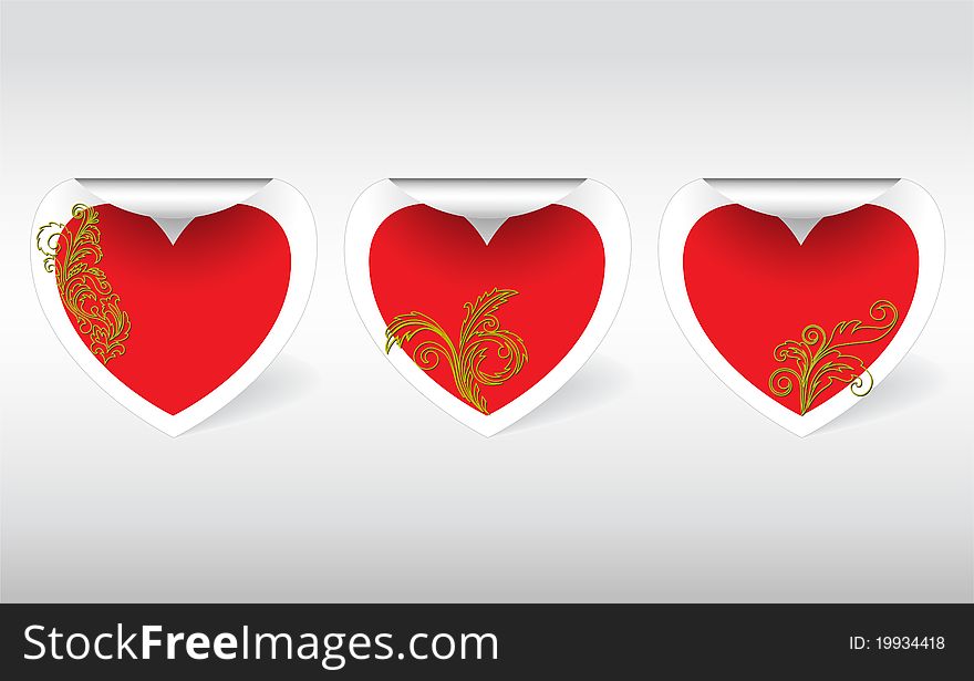 Three swirl sticker in the shape of hearts with golden ornaments. Three swirl sticker in the shape of hearts with golden ornaments