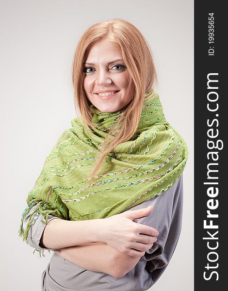 Positive young woman posing for camera in studio