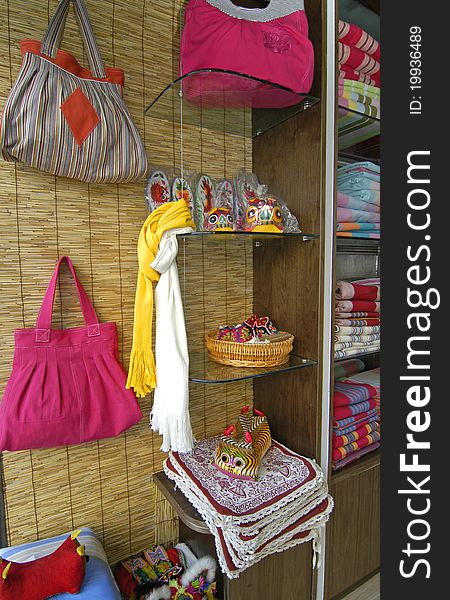 Hand bags made of cloth and accessories hanging in the store. Hand bags made of cloth and accessories hanging in the store