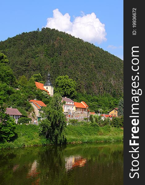 Few buildings of small village by the river under the hill. Few buildings of small village by the river under the hill