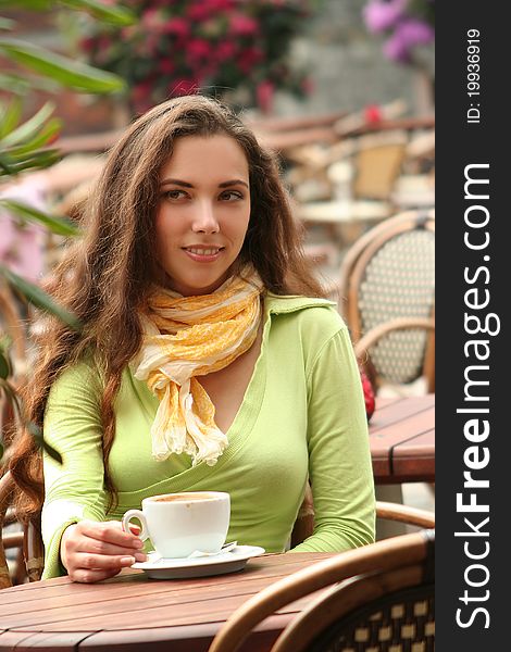 Attractive young woman relaxing in cafe. Attractive young woman relaxing in cafe