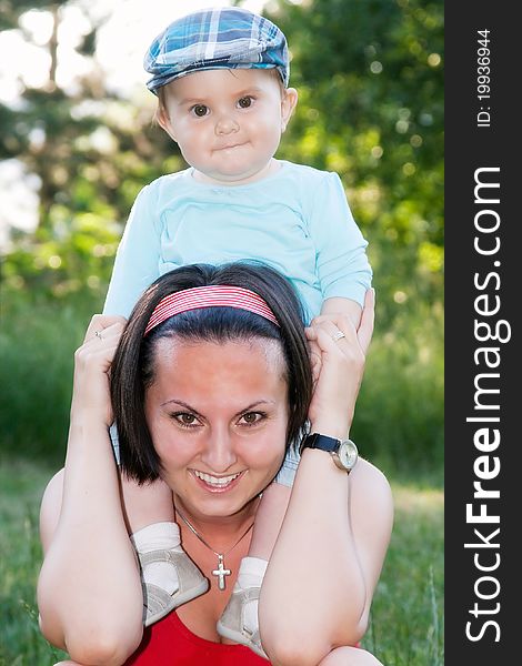 Cute little baby boy with mother outdoors