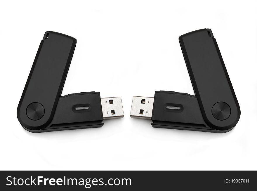 Close up of two black usb sd card adaptors arranged over white. Close up of two black usb sd card adaptors arranged over white