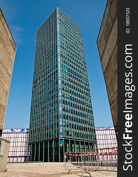 Skyscraper tall tower block in city center with railings on the bottom. Skyscraper tall tower block in city center with railings on the bottom