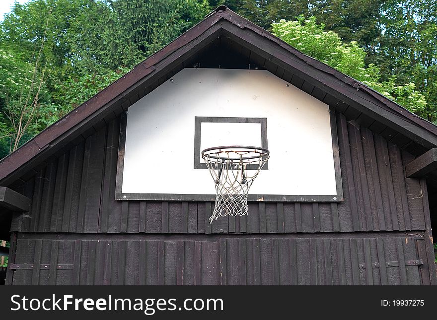 Detail of basketball board on the wall of a wooden house.