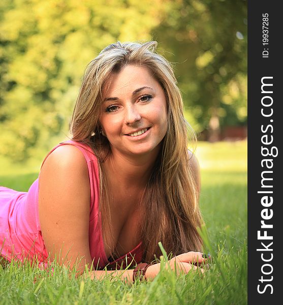 Beautiful young woman relaxing on a grass. Beautiful young woman relaxing on a grass