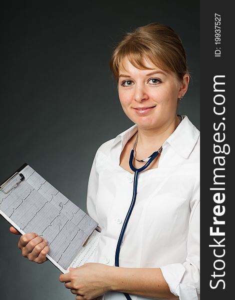 Doctor with stethoscope and electrocardiogram