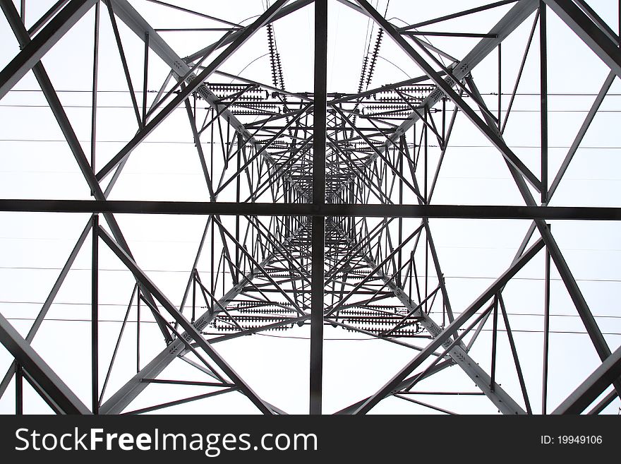 View of a high voltage electric pylon from the bottom of inside