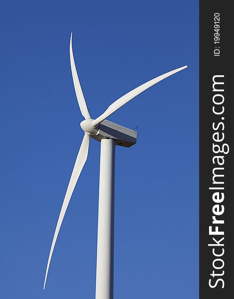 Single Wind Turbine for alternative energy production against clear blue sky. Single Wind Turbine for alternative energy production against clear blue sky