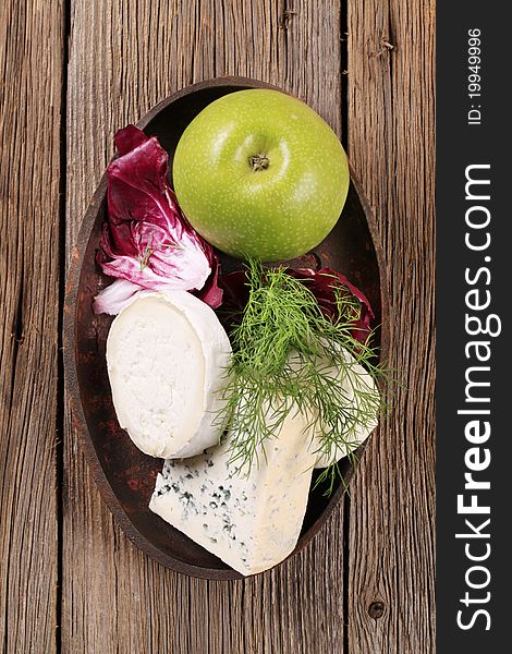 Various kinds of cheese, fresh radicchio and apple. Various kinds of cheese, fresh radicchio and apple