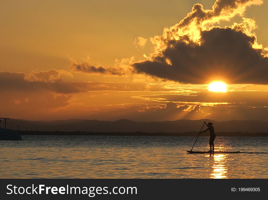 Private Golden Sunset For This Lucky Stand Up Silhouetted Sportswoman At The Paradise Village Of Barra Grande, Bahia, Brazil.