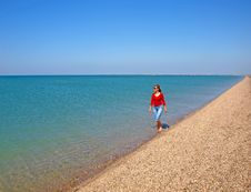 Young Woman Walking On A Coastline Royalty Free Stock Photography Young Woman Walking On A Coastline Royalty Free Stock Photography