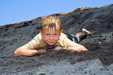 Boy Has Fun Lying In The  Black Beach Stock Image