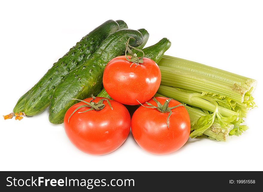 Tomatoes, cucumbers, celery lie on a table